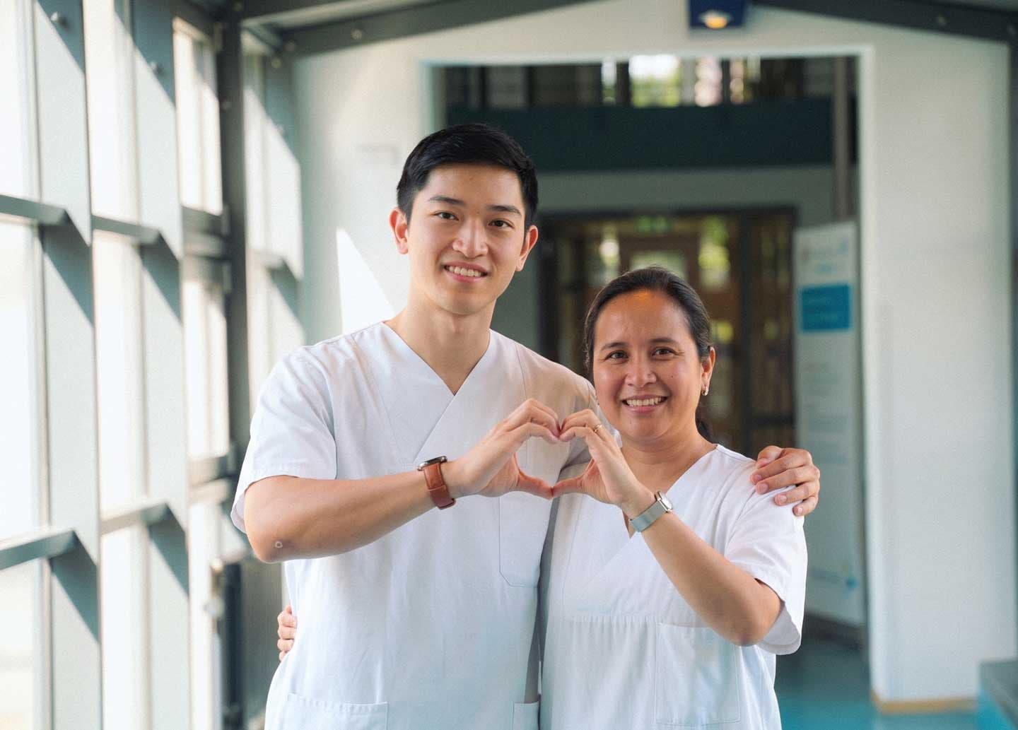 Paola and Michael, two international nurses, smiling together.